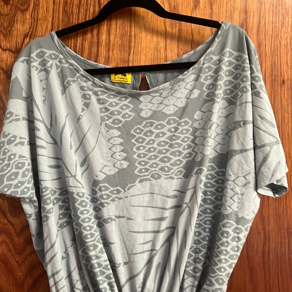 Kealopiko romper light blue gray in color.